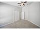 Neutral bedroom with a ceiling fan, carpeted floor, and closet at 2811 Butterfly Landing Dr, Land O Lakes, FL 34638