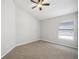 Carpeted bedroom with neutral walls, a ceiling fan, and a window at 2811 Butterfly Landing Dr, Land O Lakes, FL 34638