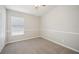 Carpeted bedroom with neutral walls, a large window, and a closet at 2811 Butterfly Landing Dr, Land O Lakes, FL 34638