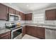 Close-up of the kitchen area showcasing stainless steel appliances, granite countertops, and a subway tile backsplash at 2811 Butterfly Landing Dr, Land O Lakes, FL 34638