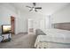 Main bedroom with a ceiling fan, carpet, and walk-in closet is spacious and well-lit at 2811 Butterfly Landing Dr, Land O Lakes, FL 34638