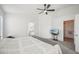 Bright main bedroom features a ceiling fan, carpet, and access to an ensuite bathroom and walk-in closet at 2811 Butterfly Landing Dr, Land O Lakes, FL 34638