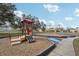 Community playground with colorful play structures and swings for Gathering fun at 2811 Butterfly Landing Dr, Land O Lakes, FL 34638