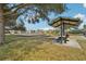 Community playground featuring picnic tables, a shaded pavilion, and ample recreational space at 2811 Butterfly Landing Dr, Land O Lakes, FL 34638