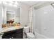 Bathroom featuring granite counters, modern sink, bathtub and tile surround at 28635 Tranquil Lake Cir, Wesley Chapel, FL 33543