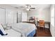 Bedroom featuring hardwood floors, ceiling fan, window with blinds and a desk area at 28635 Tranquil Lake Cir, Wesley Chapel, FL 33543