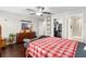 Bedroom boasting hardwood floors, ceiling fan, closet and a mounted TV at 28635 Tranquil Lake Cir, Wesley Chapel, FL 33543