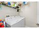 Laundry room featuring white washer and dryer, with wire shelving above at 28635 Tranquil Lake Cir, Wesley Chapel, FL 33543