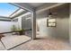 This screened-in patio has brick flooring, a ceiling fan, and a door that leads inside at 28635 Tranquil Lake Cir, Wesley Chapel, FL 33543