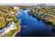 Expansive view of a home on the river with mature trees, landscaping and a private dock at 2902 N Shoreview Pl, Tampa, FL 33602