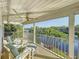 Enjoy the breezes on this covered balcony featuring chairs, ottomans, and views of palm trees and water at 2902 N Shoreview Pl, Tampa, FL 33602