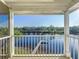 Covered porch offers waterfront view of a wooden dock extending into the beautiful lake at 2902 N Shoreview Pl, Tampa, FL 33602