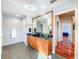 Modern bathroom features gray tile floors, wood cabinets, granite counters, and a decorative mirror frame at 2902 N Shoreview Pl, Tampa, FL 33602