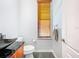 Powder room with dark granite countertops and a wooden window blind, and a commode at 2902 N Shoreview Pl, Tampa, FL 33602