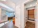 Hallway view of the primary bathroom, with granite countertops, glass shower, and soaking tub at 2902 N Shoreview Pl, Tampa, FL 33602