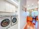 Open laundry room featuring a washer, dryer, and cabinetry, near the kitchen for convenience at 2902 N Shoreview Pl, Tampa, FL 33602