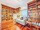 A cozy living room features wooden built-in bookshelves, a comfortable couch, and hardwood floors at 2902 N Shoreview Pl, Tampa, FL 33602