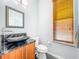 Elegant powder room featuring a granite countertop, under-mount sink, and contemporary fixtures at 2902 N Shoreview Pl, Tampa, FL 33602