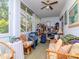 Casual sunroom filled with furniture, storage and plenty of light at 300 Glennes Ln # 208, Dunedin, FL 34698