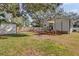 View of the backyard showcasing the home's wooden deck, storage shed, and well-maintained lawn at 321 W Wilder Ave, Tampa, FL 33603