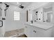 Modern bathroom with double shower head, glass partition and vanity with white cabinets at 321 W Wilder Ave, Tampa, FL 33603