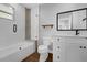 Chic bathroom with a built-in shelf and tiled shower over tub at 321 W Wilder Ave, Tampa, FL 33603