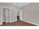 Neutral bedroom with wood-look flooring, closet with drawers, and door into another room at 321 W Wilder Ave, Tampa, FL 33603