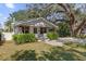 Inviting home showcasing lush greenery, highlighted by its white facade, decorative pillars, and a manicured lawn at 321 W Wilder Ave, Tampa, FL 33603