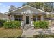 Charming home featuring a well-manicured lawn, complemented by a white facade and beautiful landscaping at 321 W Wilder Ave, Tampa, FL 33603