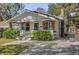 Quaint home boasting a tidy yard, distinguished by its white exterior and decorative landscaping accents at 321 W Wilder Ave, Tampa, FL 33603