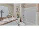 Clean bathroom featuring a shower-tub combo, white fixtures, and neutral tones for a modern and minimalist aesthetic at 4006 112Th E St, Palmetto, FL 34221