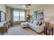 Cozy living room featuring plush carpeting, a comfortable sofa, large windows, and a television on a wood media center at 4006 112Th E St, Palmetto, FL 34221