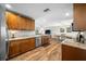 Open concept kitchen featuring granite countertops and wood flooring at 4043 93Rd N Ter, Pinellas Park, FL 33782