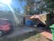 View of backyard area, including table with umbrella and a parked vehicle at 4208 N 31St St, Tampa, FL 33610