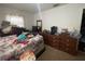 Bedroom featuring a comfortable bed, dark-wood dressers, and carpeted floors at 4208 N 31St St, Tampa, FL 33610