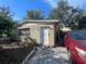 Shows the exterior with a white door, matching trim, and adjacent parked car at 4208 N 31St St, Tampa, FL 33610