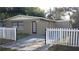 Charming single-story home with a well-maintained lawn and a classic white picket fence at 4208 N 31St St, Tampa, FL 33610