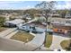 Aerial shot of a well-maintained home with a green lawn, a long driveway, and a fenced backyard at 4414 W Paris St, Tampa, FL 33614