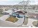 Aerial shot of a well-maintained home with a green lawn, a long driveway, and a fenced backyard at 4414 W Paris St, Tampa, FL 33614