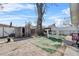 Fenced backyard featuring a shed, seating area, large tree, and a well-maintained lawn at 4414 W Paris St, Tampa, FL 33614