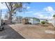 View of the spacious backyard with a large tree and a storage shed at 4414 W Paris St, Tampa, FL 33614