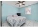 Cozy bedroom with ceiling fan, window, and comfortable bed, and tile floors at 4414 W Paris St, Tampa, FL 33614