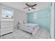 Bedroom features ceiling fan, tile floor, closet, and window at 4414 W Paris St, Tampa, FL 33614