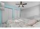 Bright bedroom features a ceiling fan, closet with double doors, and gray walls with a pastel accent wall at 4414 W Paris St, Tampa, FL 33614