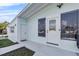 Light blue and white exterior features a front door with windows, a second door and a concrete walkway at 4414 W Paris St, Tampa, FL 33614