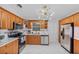 Contemporary kitchen with wooden cabinets, stainless steel appliances, and modern white tile backsplash at 4414 W Paris St, Tampa, FL 33614