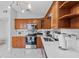 Well-lit kitchen features wooden cabinets, stainless steel appliances, and quartz countertops at 4414 W Paris St, Tampa, FL 33614