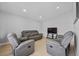 Well-lit living room showcasing neutral color palette, recessed lighting, and a cozy seating area at 4414 W Paris St, Tampa, FL 33614