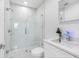 Modern bathroom with tiled shower, vanity and sleek fixtures at 4716 Eldorado Dr, Tampa, FL 33615