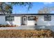 Charming single-story home featuring a modern white exterior, dark trim and a well maintained lawn at 4716 Eldorado Dr, Tampa, FL 33615